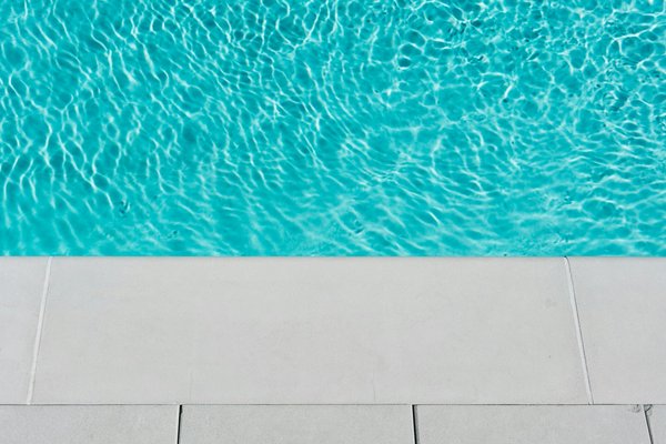 What are the best materials for pool coping that can endure the UK's weather conditions?